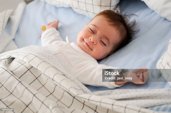 A child peacefully sleeping on a cozy bed, with soft lighting creating a tranquil atmosphere