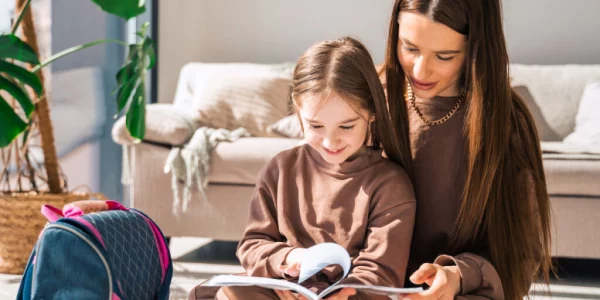 Parents reading books on sexual education with their child, creating a safe space for discussions